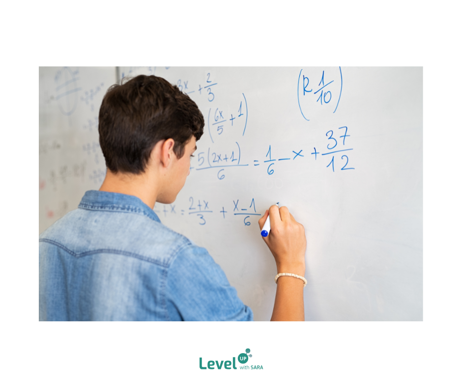 Student standing at a whiteboard writing mathematical equations